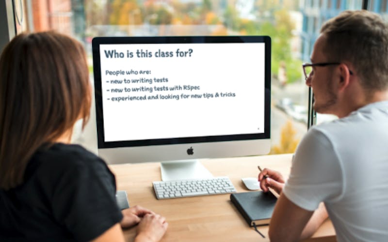 Two people looking at a desktop monitor that reads who is this class for?